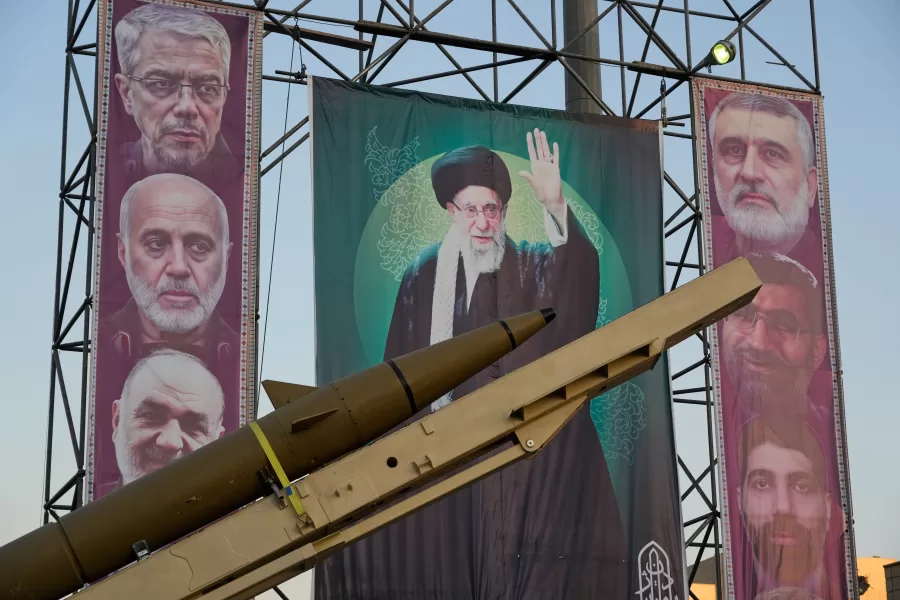 A domestically-built missile “Khaibar-buster,” and banners showing portraits of the Iranian Supreme Leader Ayatollah Ali Khamenei, center, and the late armed forces commanders, who were killed in Israeli strike in June, are displayed in a military exhibition commemorating the anniversary of the start of the 1980-88 Iraq-Iran war, and 12-day war with Israel in June, at Baharestan Square, in Tehran, Thursday, Sept. 25, 2025. (AP Photo/Vahid Salemi)