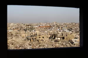 A view through a window shows widespread destruction across Jabalia, in the northern Gaza Strip, Sunday, Dec. 7, 2025. (AP Photo/Jehad Alshrafi)
