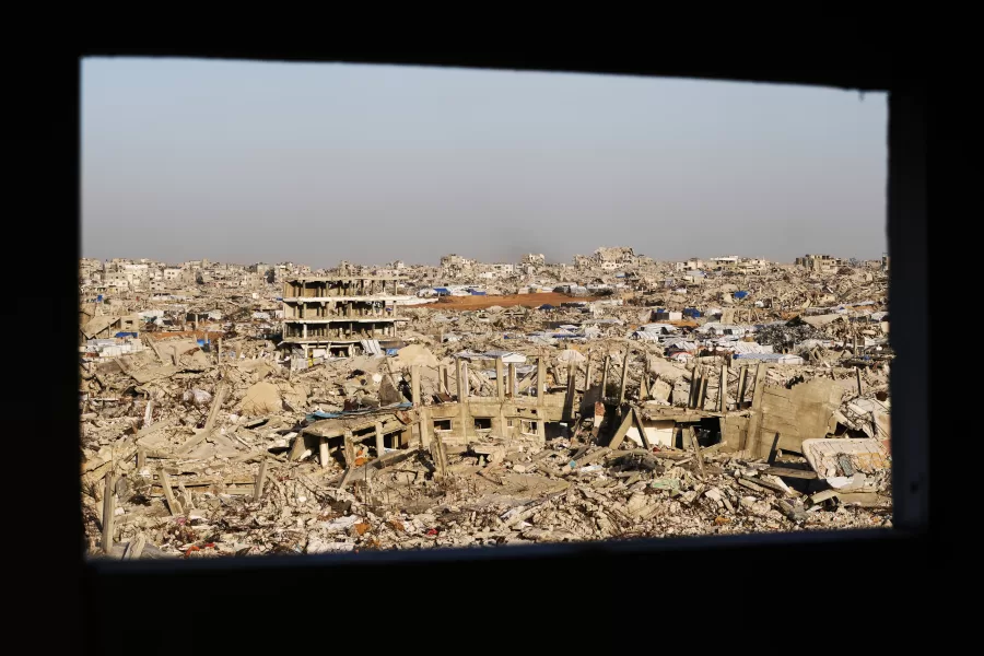 A view through a window shows widespread destruction across Jabalia, in the northern Gaza Strip, Sunday, Dec. 7, 2025. (AP Photo/Jehad Alshrafi)