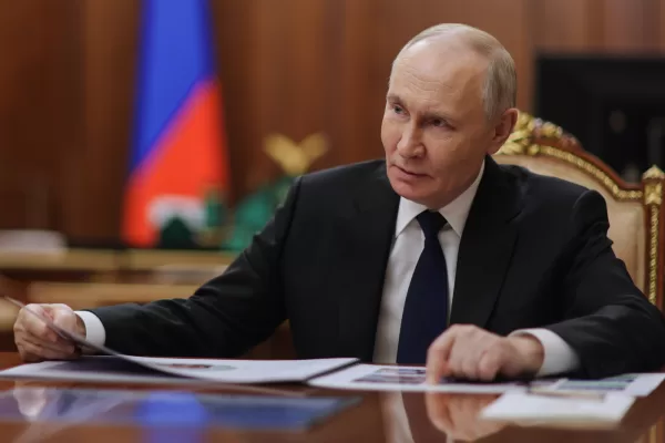 Russian President Vladimir Putin listens to Russian Deputy Defense Minister and chairwoman of the Defenders of the Fatherland Foundation Anna Tsivileva during their meeting at the Kremlin in Moscow, Russia, Tuesday, Dec. 30, 2025. (Mikhail Metzel/Sputnik, Kremlin Pool Photo via AP)