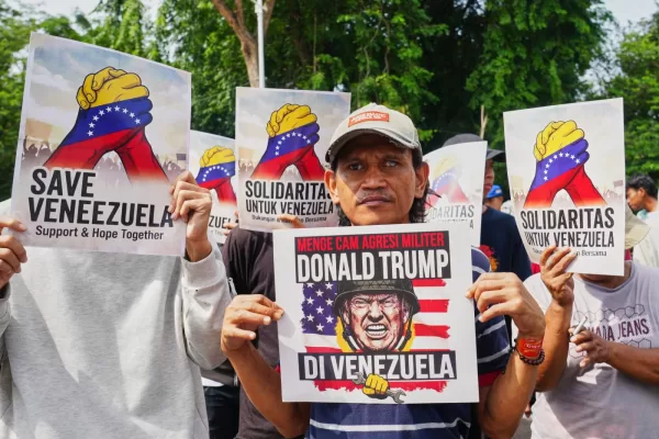 A protester holds a placard during a rally outside the U.S. Embassy in Jakarta, Indonesia denouncing the U.S.capture of Venezuelan President Nicolas Maduro, Tuesday, Jan. 6, 2026. Placard reads, “denounce Donald Trump’s military aggression in Venezuela”. (AP Photo/Tatan Syuflana)