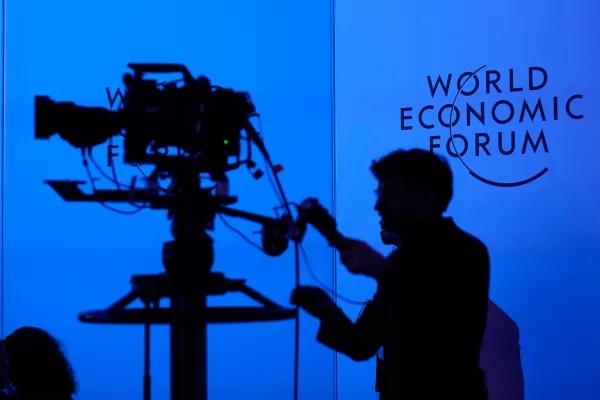 A camera man is seen on the final day of the Annual Meeting of the World Economic Forum in Davos, Switzerland, Friday, Jan. 23, 2026. (AP Photo/Markus Schreiber)