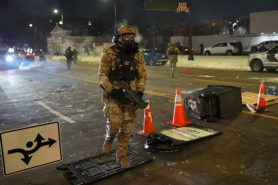Federal agents try to clear the demonstrators near a hotel, using tear gas during a noise demonstration protest in response to federal immigration enforcement operations in the city Sunday, Jan. 25, 2026, in Minneapolis. (AP Photo/Adam Gray)
