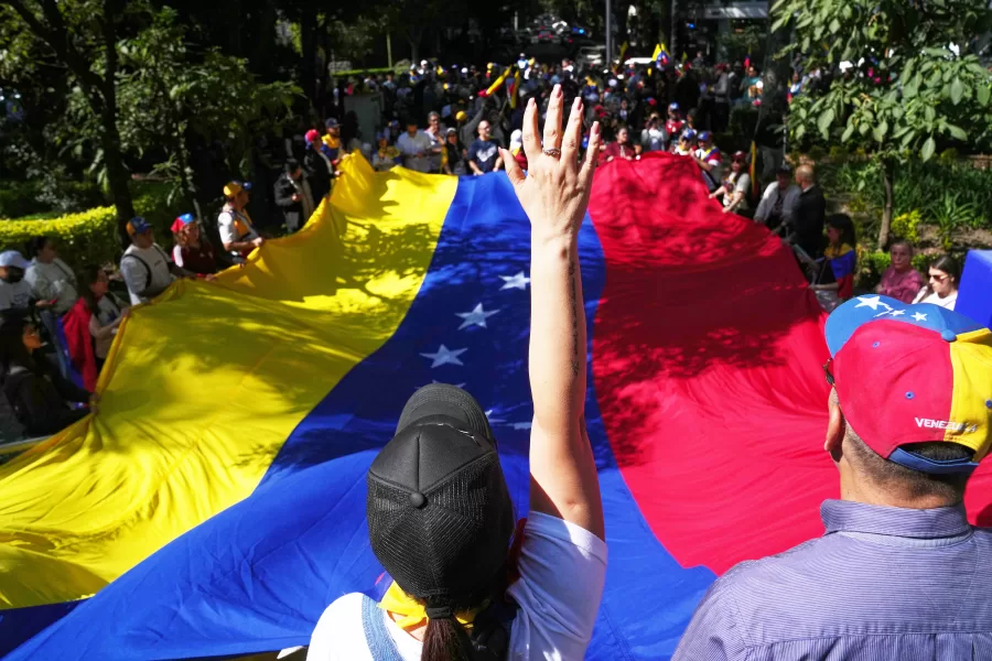 Supporters of Venezuela’s opposition hold a National flag as they celebrate in Mexico City, Sunday, Jan. 4, 2026, a day after U.S. forces captured President Nicolas Maduro and flew him to the United States. (AP Photo/Marco Ugarte)