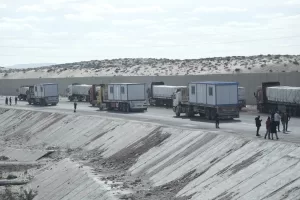 Truck drivers, transporting humanitarian aids, wait at the Baloza check point, on their way to cross the Rafah border crossing between Egypt and the Gaza Strip, Sunday, Jan. 19, 2025. (AP Photo/Amr Nabil)