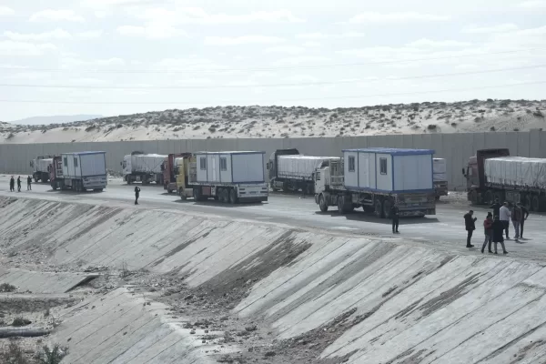 Truck drivers, transporting humanitarian aids, wait at the Baloza check point, on their way to cross the Rafah border crossing between Egypt and the Gaza Strip, Sunday, Jan. 19, 2025. (AP Photo/Amr Nabil)