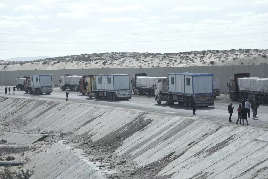 Truck drivers, transporting humanitarian aids, wait at the Baloza check point, on their way to cross the Rafah border crossing between Egypt and the Gaza Strip, Sunday, Jan. 19, 2025. (AP Photo/Amr Nabil)
