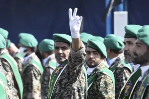 FILE – A member of Iran’s Basij paramilitary force flashes a victory sign during a military parade outside of Tehran, Iran, on Sept. 22, 2022. (AP Photo/Vahid Salemi, File)