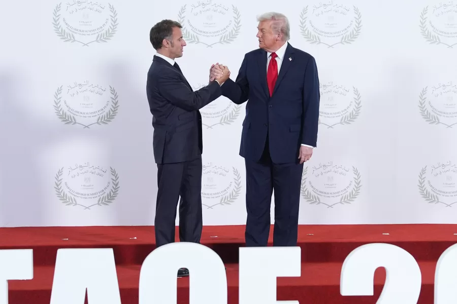 President Donald Trump greets France’s President Emmanuel Macron during summit to support ending the more than two-year Israel-Hamas war in Gaza after a breakthrough ceasefire deal, Monday, Oct. 13, 2025, in Sharm El Sheikh, Egypt. (AP Photo/Evan Vucci, Pool)