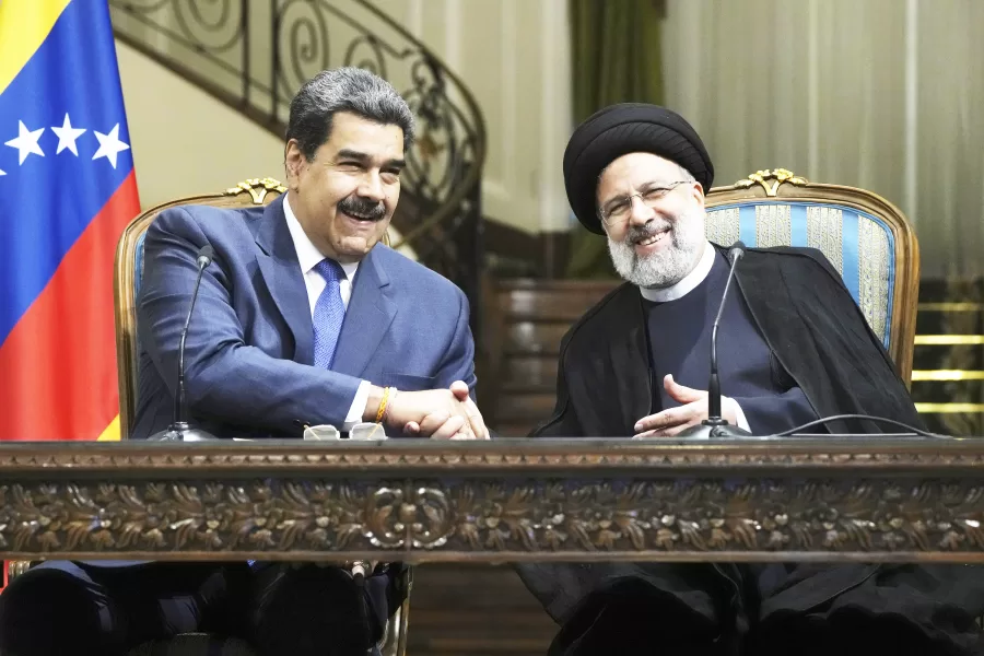 Iranian President Ebrahim Raisi, right, and his Venezuelan counterpart Nicolas Maduro shake hands at the conclusion of their joint news briefing at the Saadabad Palace in Tehran, Iran, Saturday, June 11, 2022. (AP Photo/Vahid Salemi)