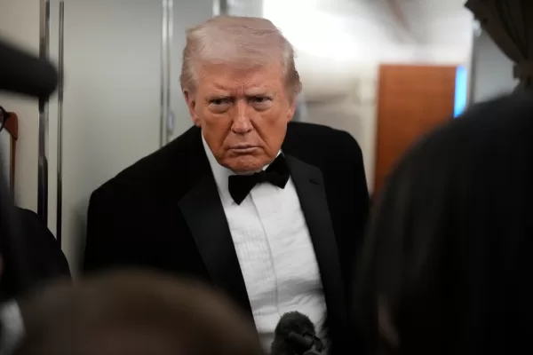 President Donald Trump speaks with reporters aboard Air Force One as he travels from Joint Base Andrews, Md. to West Palm Beach, Fla., Saturday, Jan. 31, 2026. (AP Photo/Mark Schiefelbein)