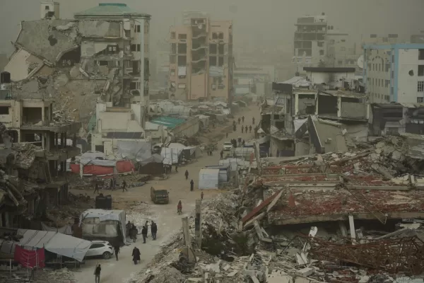 Palestinians walk along a street surrounded by buildings destroyed in Israeli air and ground operations during a dust storm in Gaza City, Saturday, Feb. 14, 2026. (AP Photo/Jehad Alshrafi) Palestinians walk along a street surrounded by buildings destroyed in Israeli air and ground operations during a dust storm in Gaza City, Saturday, Feb. 14, 2026. (AP Photo/Jehad Alshrafi)