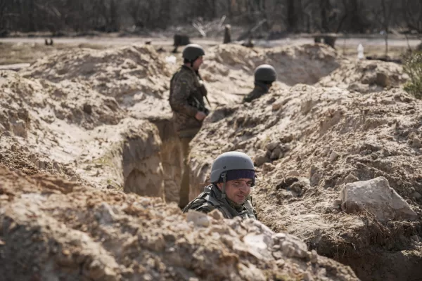 Ukrainian servicemen stand in trenches at a position north of the capital Kyiv, Ukraine, Tuesday, March 29, 2022. The first face-to-face talks in two weeks between Russia and Ukraine began Tuesday in Turkey, raising flickering hopes there could be progress toward ending a war that has ground into a bloody campaign of attrition. (AP Photo/Vadim Ghirda)