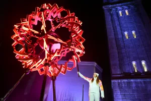 Final torchbearer Italian skier Sofia Goggia holds the torch of the Olympic flame to light the Olympic cauldron designed by Marco Balich during the Olympic opening ceremony at the 2026 Winter Olympics, in in Cortina d’Ampezzo, Italy, Friday, Feb. 6, 2026. (Stefano Rellandini/Pool Photo via AP)