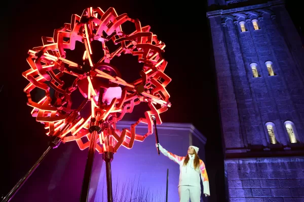 Final torchbearer Italian skier Sofia Goggia holds the torch of the Olympic flame to light the Olympic cauldron designed by Marco Balich during the Olympic opening ceremony at the 2026 Winter Olympics, in in Cortina d’Ampezzo, Italy, Friday, Feb. 6, 2026. (Stefano Rellandini/Pool Photo via AP)
