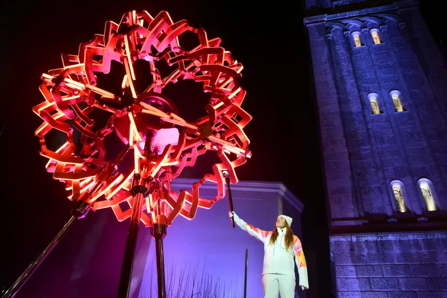 Final torchbearer Italian skier Sofia Goggia holds the torch of the Olympic flame to light the Olympic cauldron designed by Marco Balich during the Olympic opening ceremony at the 2026 Winter Olympics, in in Cortina d’Ampezzo, Italy, Friday, Feb. 6, 2026. (Stefano Rellandini/Pool Photo via AP)