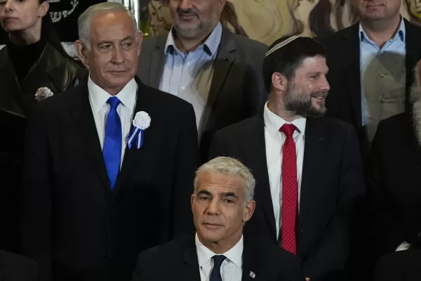 FILE-Israeli Prime Minister Yair Lapid, center, Likud Party leader Benjamin Netanyahu, left, far-right Israeli lawmaker Bezalel Smotrich and leaders of all Israel’s political parties pose for a group photo after the swearing-in ceremony for Israeli lawmakers at the Knesset, Israel’s parliament, in Jerusalem, Tuesday, Nov. 15, 2022. Israel’s designated prime minister, Benjamin Netanyahu, has announced a coalition deal with a hardline pro-settler party on Thursday, Dec. 1, 2022. The agreement will give Religious Zionism control over a number of key government ministries and a senior post over West Bank settlement construction. (AP Photo/Tsafrir Abayov, File)