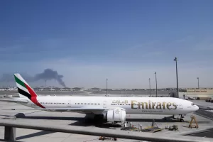An Emirates plane is parked at the Dubai International Airport after its closure in Dubai, United Arab Emirates, Sunday, March 1, 2026. (AP Photo/Altaf Qadri)