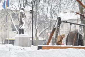 Ukrainian police officers work at the site of a Russian drone strike on a children playground near a monument to Stepan Bandera, a founder of a rebel army that fought against the Soviet regime, in Lviv, western Ukraine, Thursday, Jan. 15, 2026. (AP Photo/Mykola Tys)