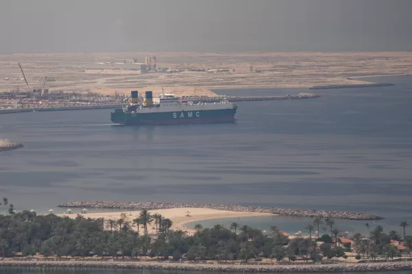 A cargo ship is seen leaving the Dubai port, United Arab Emirates, Sunday, March 15, 2026. (AP Photo/Altaf Qadri)