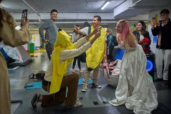 People attend a joint bachelor and bachelorette party in an underground parking garage, as a precaution against the threat of possible Iranian missile attacks in Tel Aviv, Israel, Tuesday, March 17, 2026. (AP Photo/Ohad Zwigenberg)