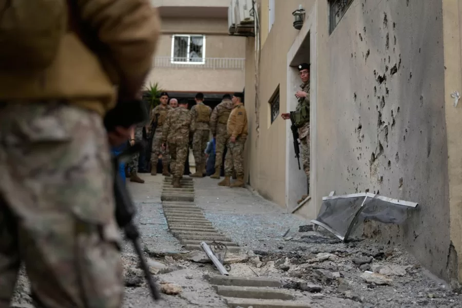 A wall is damaged where Lebanese army soldiers stand guard after intercepted missiles fell in Sahel Alma, north of Beirut, Lebanon, Tuesday, March 24, 2026. (AP Photo/Hassan Ammar)