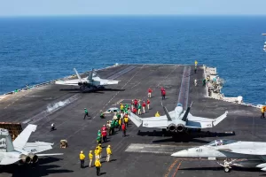 This image provided by U.S. Central Command shows a F/A-18E Super Hornet launching at left, as an F/A-18E Super at right, prepares to launch from the flight deck of Nimitz-class aircraft carrier USS Abraham Lincoln (CVN 72) in support of Operation Epic Fury, on Saturday, Feb. 28, 2026. (U.S. Navy via AP)