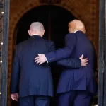 President Donald Trump and Israel’s Prime Minister Benjamin Netanyahu walk into Trump’s Mar-a-Lago club, Monday, Dec. 29, 2025, in Palm Beach, Fla., after an arrival greeting. (AP Photo/Alex Brandon)
