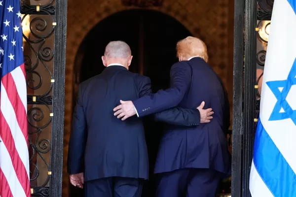 President Donald Trump and Israel’s Prime Minister Benjamin Netanyahu walk into Trump’s Mar-a-Lago club, Monday, Dec. 29, 2025, in Palm Beach, Fla., after an arrival greeting. (AP Photo/Alex Brandon)
