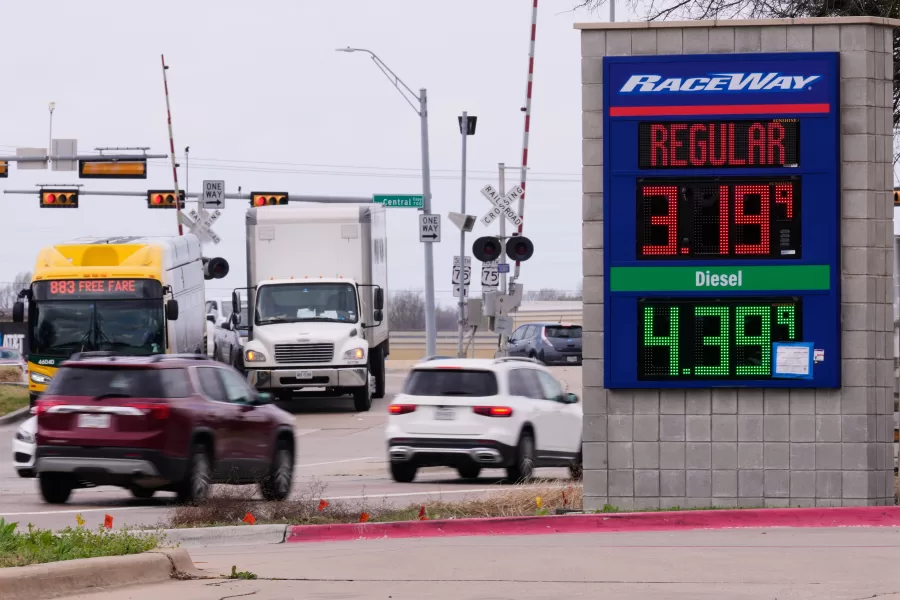 Drivers navigate a busy intersection past a sign displaying the current gas prices at a filling station in Plano, Texas, Friday, March 6, 2026. (AP Photo/Tony Gutierrez)