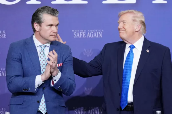 President Donald Trump speaks with Defense Secretary Pete Hegseth during a roundtable discussion on public safety at a Tennessee Air National Guard Base, Monday, March 23, 2026, in Memphis, Tenn. (AP Photo/Mark Schiefelbein)