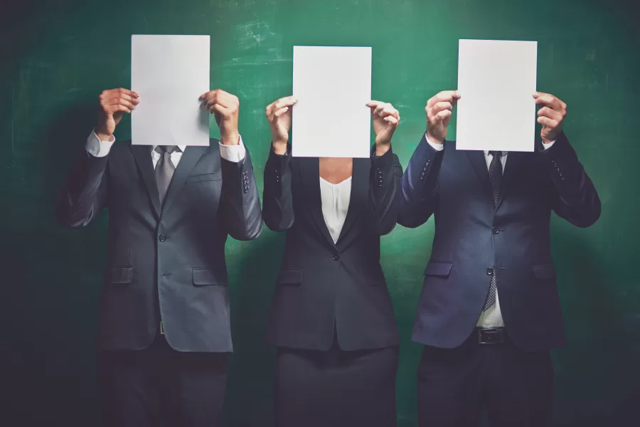 Elegant business partners holding blank papers on green background