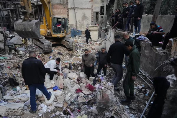 Civilians and rescue workers search through rubble at the site of a building where efforts continue to recover the body of missing woman Zahraa Aboud, 26, after it was destroyed in an Israeli airstrike on Wednesday, in central Beirut, Sunday, April 12, 2026. (AP Photo/Hassan Ammar)