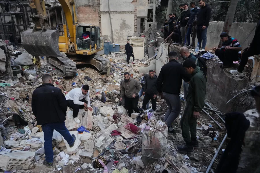 Civilians and rescue workers search through rubble at the site of a building where efforts continue to recover the body of missing woman Zahraa Aboud, 26, after it was destroyed in an Israeli airstrike on Wednesday, in central Beirut, Sunday, April 12, 2026. (AP Photo/Hassan Ammar)