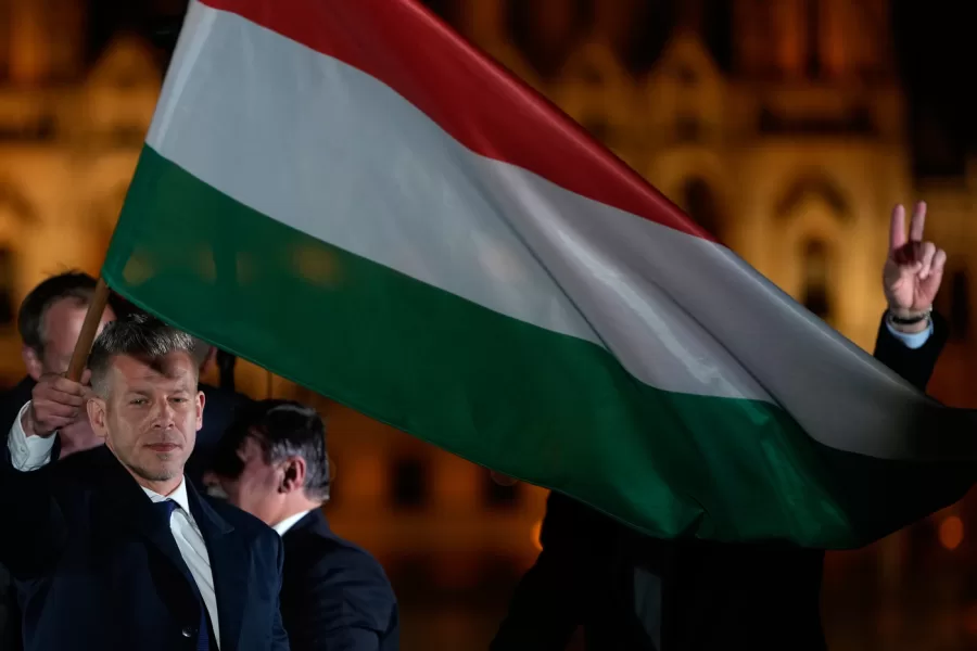 Peter Magyar, the leader of the opposition Tisza party waves a national flag after claiming victory in a parliamentary election in Budapest, Hungary, Sunday, April 12, 2026. (AP Photo/Darko Bandic)