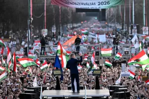 Opposition leader Peter Magyar, center, addresses his supporters during a march in Budapest, Sunday, March 15, 2026. (AP Photo/Denes Erdos)
