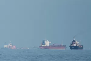 FILE – Oil tankers and cargo ships line up in the Strait of Hormuz as seen from Khor Fakkan, United Arab Emirates, Wednesday, March 11, 2026. (AP Photo/Altaf Qadri,File)