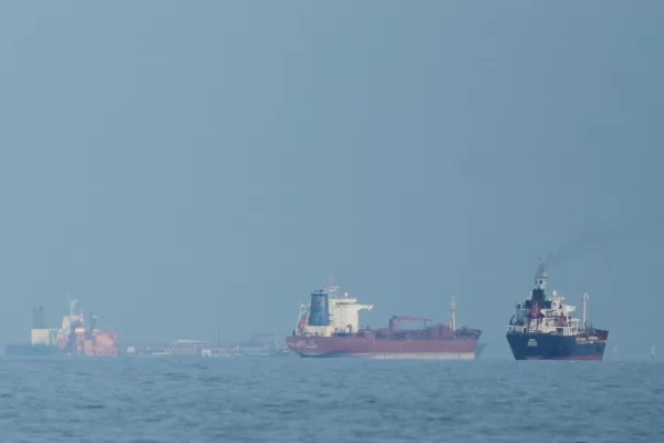 FILE – Oil tankers and cargo ships line up in the Strait of Hormuz as seen from Khor Fakkan, United Arab Emirates, Wednesday, March 11, 2026. (AP Photo/Altaf Qadri,File)