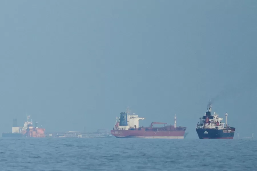 FILE – Oil tankers and cargo ships line up in the Strait of Hormuz as seen from Khor Fakkan, United Arab Emirates, Wednesday, March 11, 2026. (AP Photo/Altaf Qadri,File)