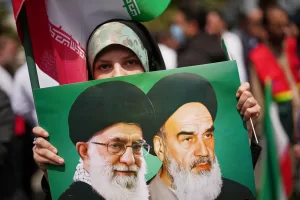 A woman holds a picture depicting the late Iran’s Supreme Leader Ayatollah Ali Khamenei, left, and the late revolutionary founder Ayatollah Ruhollah Khomeini during a government-sponsored protest attended by medical workers against the U.S.-Israeli military campaign outside Imam Khomeini Hospital in Tehran, Iran, Monday, April 6, 2026. (AP Photo/Francisco Seco) A woman holds a picture depicting the late Iran’s Supreme Leader Ayatollah Ali Khamenei, left, and the late revolutionary founder Ayatollah Ruhollah Khomeini during a government-sponsored protest attended by medical workers against the U.S.-Israeli military campaign outside Imam Khomeini Hospital in Tehran, Iran, Monday, April 6, 2026. (AP Photo/Francisco Seco)