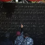 People point at different shields on NASA’s Artemis II capsule aboard the USS John P. Murtha at Naval Base San Diego Saturday, April 11, 2026, in San Diego. (AP Photo/Gregory Bull)