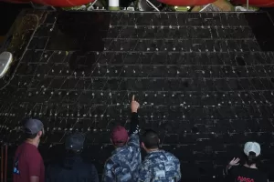 People point at different shields on NASA’s Artemis II capsule aboard the USS John P. Murtha at Naval Base San Diego Saturday, April 11, 2026, in San Diego. (AP Photo/Gregory Bull)