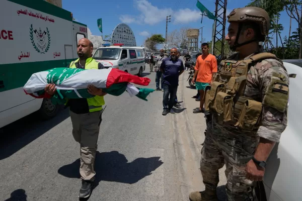 A paramedic volunteer carries a body, one of the six the family members who were killed on Wednesday when their car was struck in an Israeli airstrike on a highway as they fled their village, during a funeral procession in the southern port city of Tyre, Lebanon, Friday, May 29, 2026. (AP Photo/Mohammed Zaatari) A paramedic volunteer carries a body, one of the six the family members who were killed on Wednesday when their car was struck in an Israeli airstrike on a highway as they fled their village, during a funeral procession in the southern port city of Tyre, Lebanon, Friday, May 29, 2026. (AP Photo/Mohammed Zaatari)