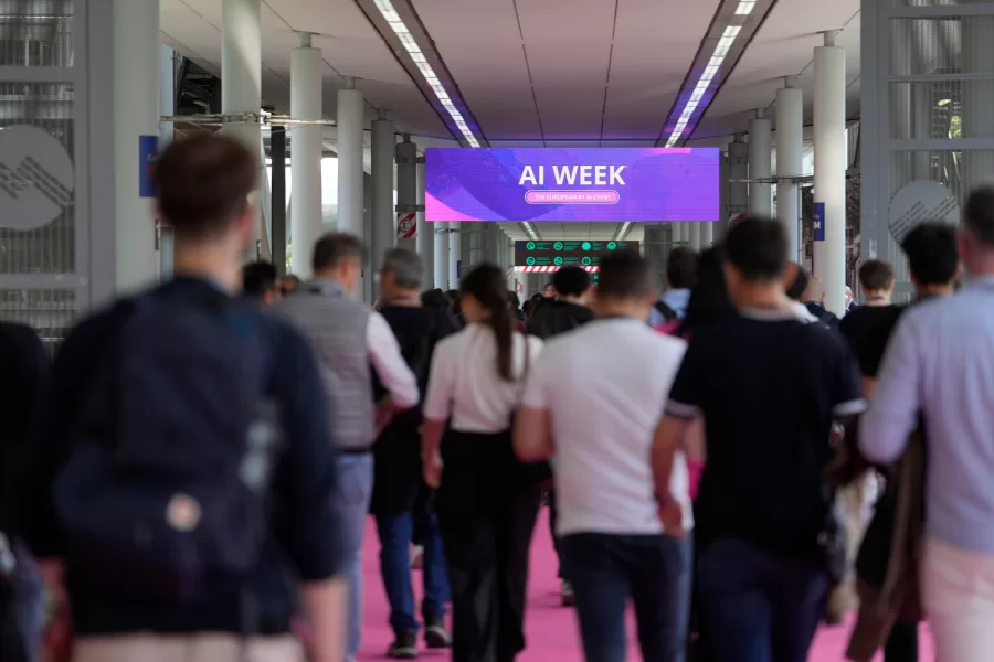 Visitors arrive to the Europelargest artificial intelligence event, AI Week 2026, in Rho, near Milan, Italy, Tuesday, May 19, 2026. (AP Photo/Luca Bruno)
