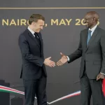 French President Emmanuel Macron, left, and Kenyan President William Ruto shake hands at State House in Nairobi, Kenya, Sunday, May 10, 2026. (AP Photo/Brian Inganga)