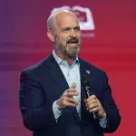 Kevin Roberts, president of The Heritage Foundation, speaks during Turning Point USA’s AmericaFest 2025, Friday, Dec. 19, 2025, in Phoenix. (AP Photo/Ross D. Franklin)
