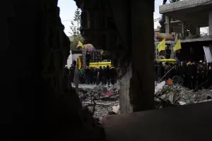 A semi transporting coffins that contain the remains of Hezbollah fighters who were killed before the ceasefire in the war between Hezbollah and Israel, drives past the rubble of a destroyed building, as part of a mass funeral procession in the southern village of Kfar Sir, Lebanon, Tuesday, April 21, 2026. (AP Photo/Hassan Ammar) A semi transporting coffins that contain the remains of Hezbollah fighters who were killed before the ceasefire in the war between Hezbollah and Israel, drives past the rubble of a destroyed building, as part of a mass funeral procession in the southern village of Kfar Sir, Lebanon, Tuesday, April 21, 2026. (AP Photo/Hassan Ammar)