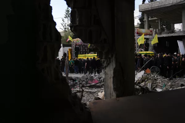 A semi transporting coffins that contain the remains of Hezbollah fighters who were killed before the ceasefire in the war between Hezbollah and Israel, drives past the rubble of a destroyed building, as part of a mass funeral procession in the southern village of Kfar Sir, Lebanon, Tuesday, April 21, 2026. (AP Photo/Hassan Ammar) A semi transporting coffins that contain the remains of Hezbollah fighters who were killed before the ceasefire in the war between Hezbollah and Israel, drives past the rubble of a destroyed building, as part of a mass funeral procession in the southern village of Kfar Sir, Lebanon, Tuesday, April 21, 2026. (AP Photo/Hassan Ammar)