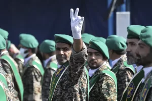 FILE – A member of Iran’s Basij paramilitary force flashes a victory sign during a military parade outside of Tehran, Iran, on Sept. 22, 2022. (AP Photo/Vahid Salemi, File) FILE – A member of Iran’s Basij paramilitary force flashes a victory sign during a military parade outside of Tehran, Iran, on Sept. 22, 2022. (AP Photo/Vahid Salemi, File)
