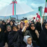 A group of women attend a mass wedding ceremony for couples participating in the “Janfada” (“Sacrifice for Iran”) pro-government campaign in Tehran, Iran, Monday, May 18, 2026. (AP Photo/Vahid Salemi)